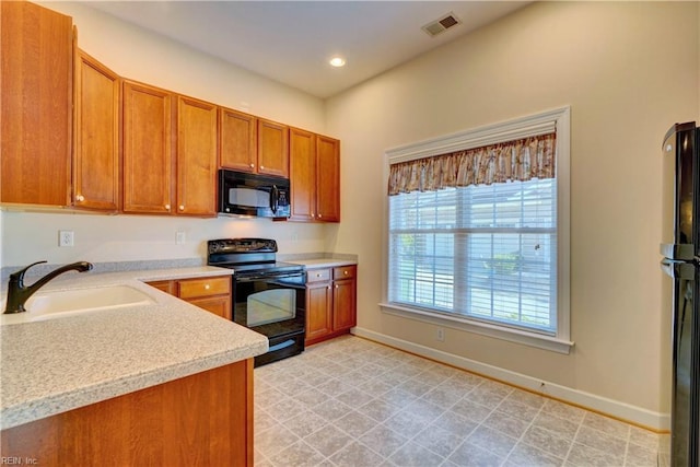 kitchen with sink and black appliances