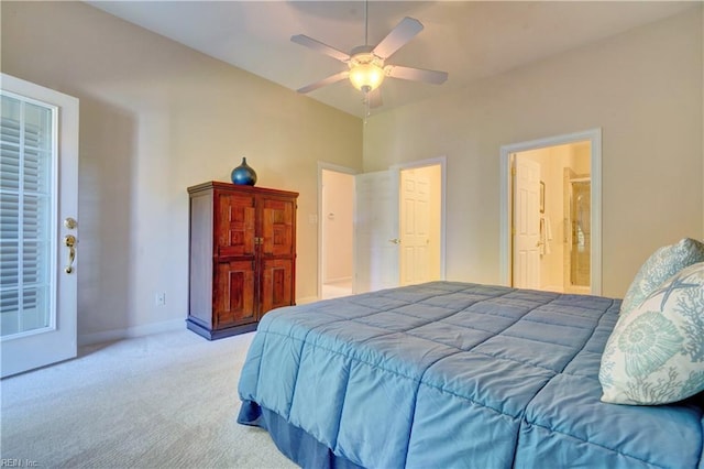 bedroom with ensuite bathroom, light carpet, and ceiling fan