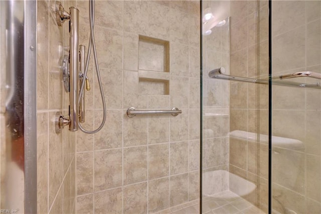 bathroom featuring a shower with door