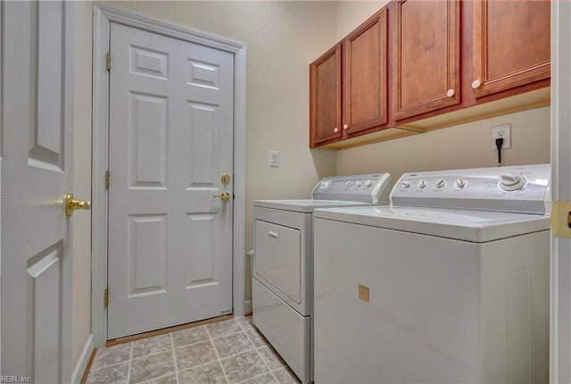 laundry area featuring cabinets and separate washer and dryer