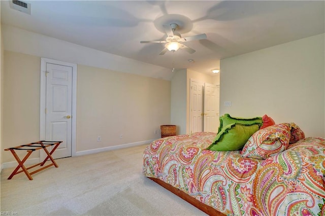 bedroom with lofted ceiling, light colored carpet, a closet, and ceiling fan