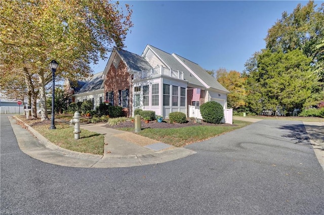 view of property exterior featuring a balcony and a garage