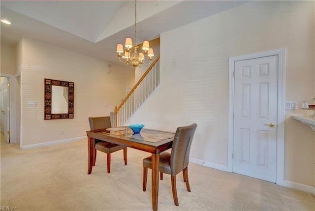 dining room with light carpet, lofted ceiling, and a chandelier