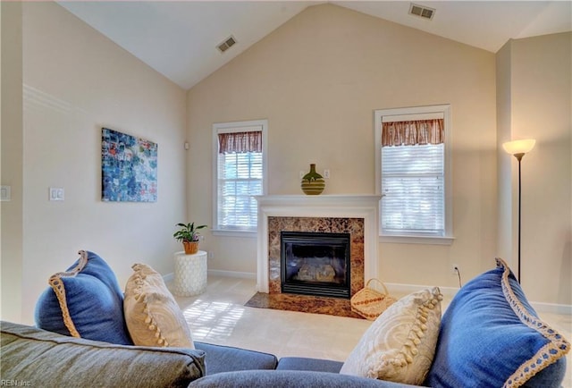 living room featuring light colored carpet, lofted ceiling, and a premium fireplace