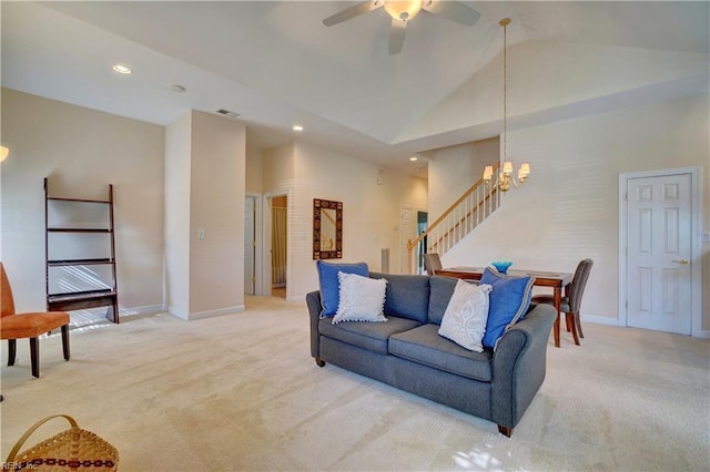 living room featuring light carpet, ceiling fan with notable chandelier, and high vaulted ceiling