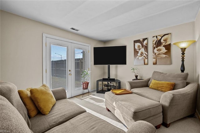 living room with carpet floors, french doors, and a wood stove