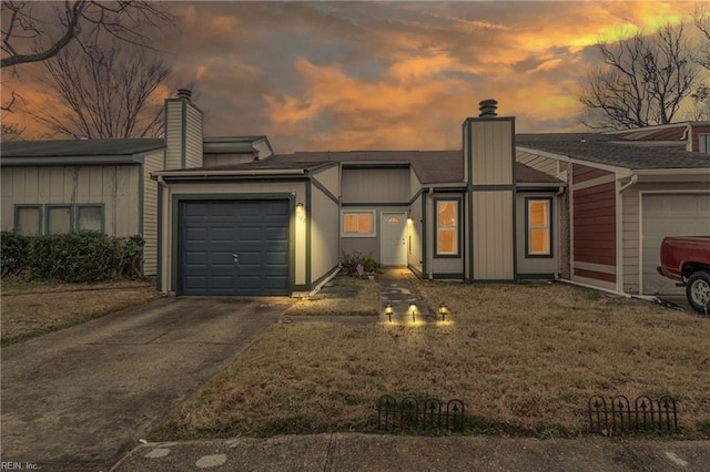 single story home with a garage and a yard