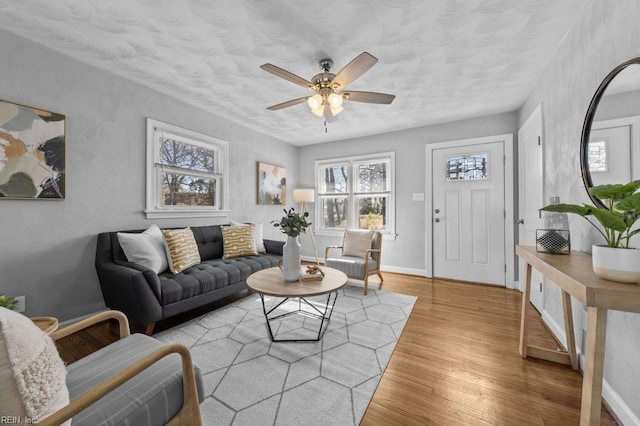 living room featuring ceiling fan and light wood-type flooring