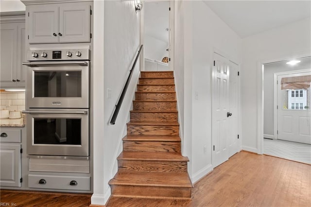 stairway with hardwood / wood-style flooring