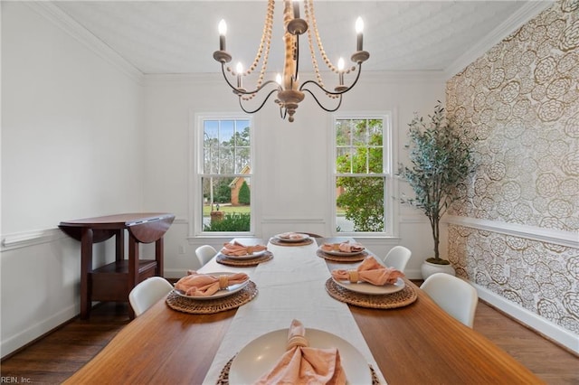 dining space featuring crown molding, dark wood-type flooring, and a notable chandelier