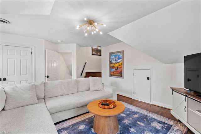 living room with lofted ceiling, dark hardwood / wood-style floors, and a chandelier