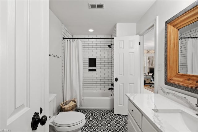 full bathroom featuring vanity, shower / tub combo with curtain, and toilet