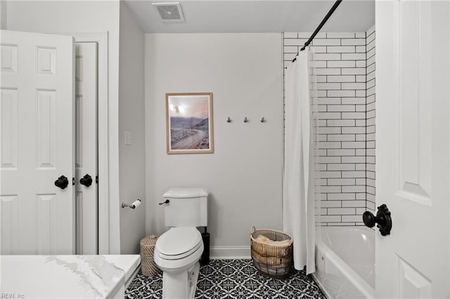 bathroom featuring tile patterned floors, shower / bath combo with shower curtain, and toilet