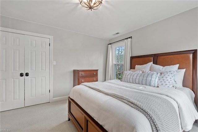 bedroom featuring light carpet and a closet