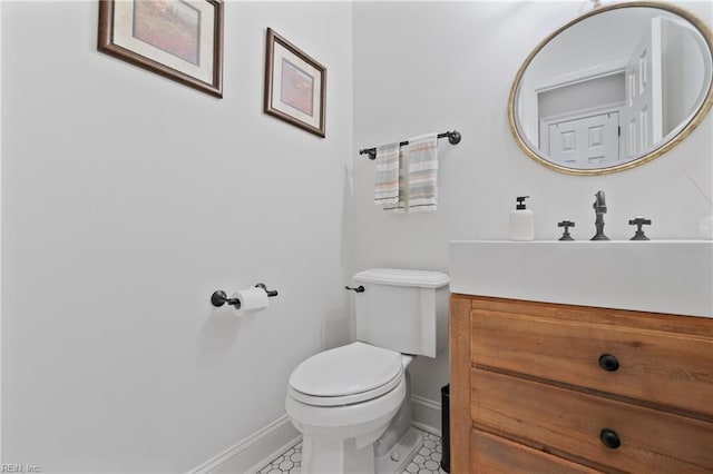 bathroom with vanity, tile patterned flooring, and toilet