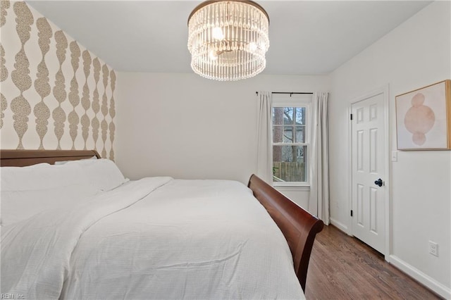 bedroom featuring hardwood / wood-style flooring and a chandelier