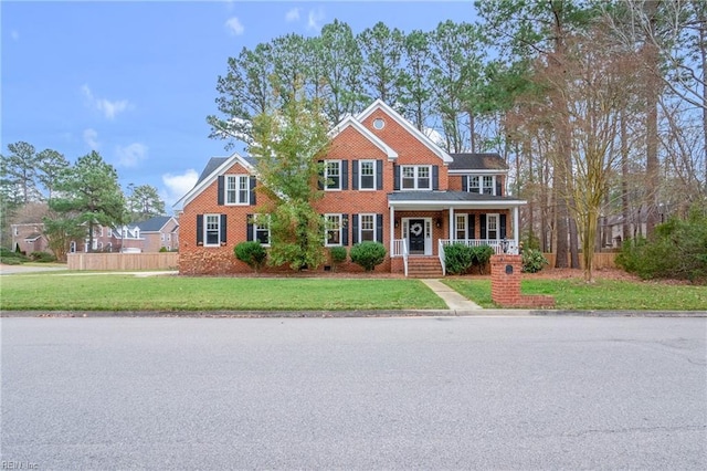 view of front of property featuring a porch and a front yard