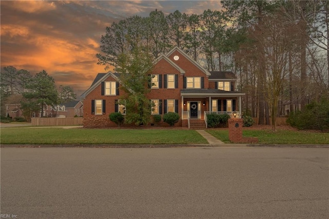 view of front facade featuring a lawn and covered porch