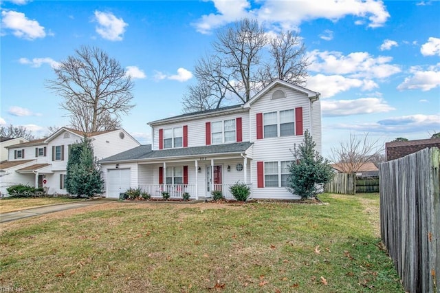 view of front of property featuring a garage, a porch, and a front yard