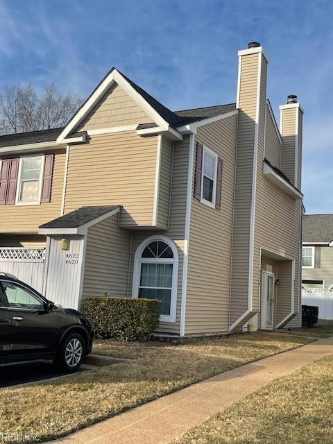 view of side of home with a garage and a lawn