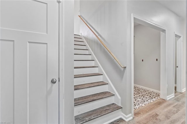 stairs featuring hardwood / wood-style flooring