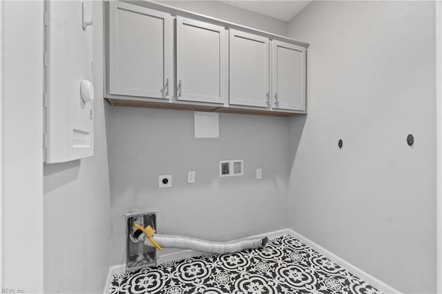 laundry room featuring cabinets, electric dryer hookup, hookup for a washing machine, and tile patterned floors