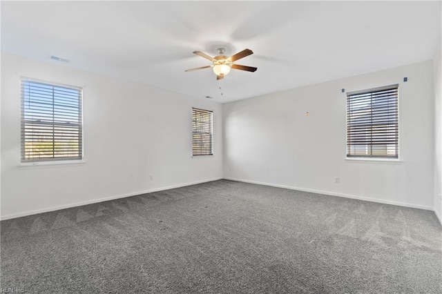 carpeted empty room featuring ceiling fan