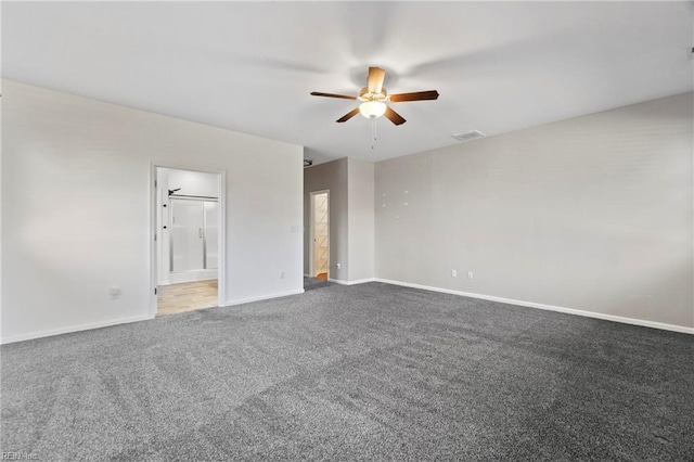 unfurnished room with ceiling fan and dark carpet