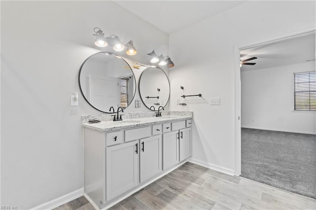 bathroom with vanity, hardwood / wood-style flooring, and ceiling fan