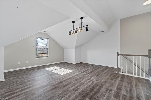 additional living space featuring lofted ceiling and dark wood-type flooring