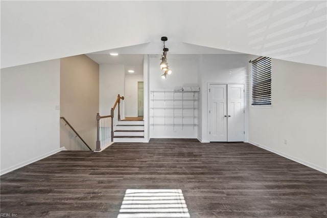 unfurnished living room with dark wood-type flooring