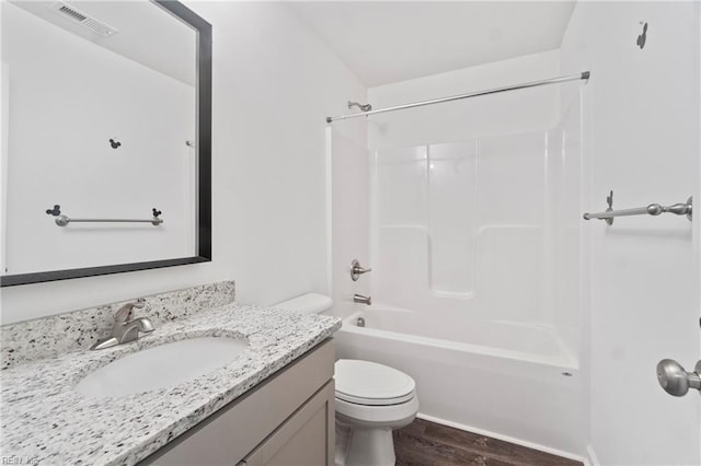 full bathroom featuring hardwood / wood-style flooring, vanity, shower / bathtub combination, and toilet