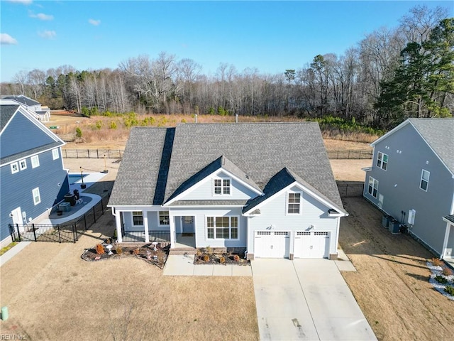 view of front of home with a porch, a garage, and a front yard