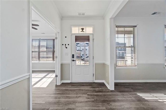 entrance foyer with dark wood-type flooring, ornamental molding, and ceiling fan