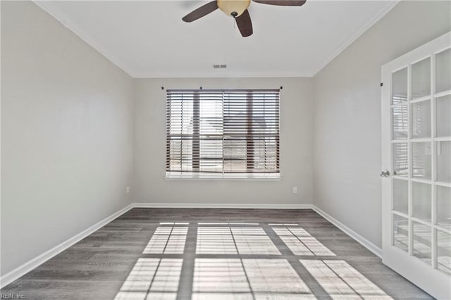 spare room featuring crown molding, ceiling fan, and dark hardwood / wood-style flooring