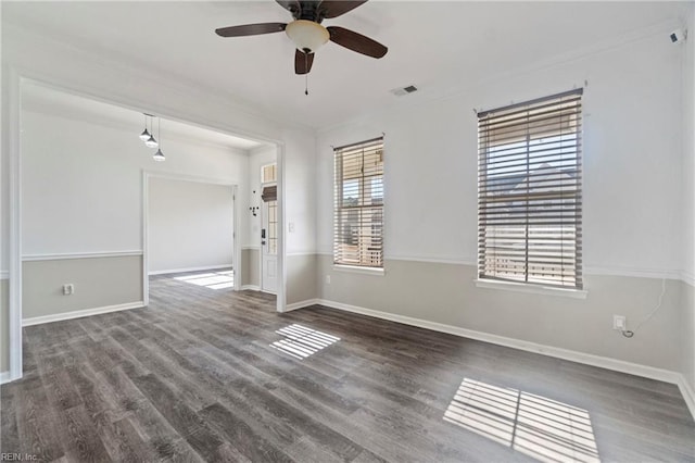 empty room featuring ceiling fan, ornamental molding, and dark hardwood / wood-style floors