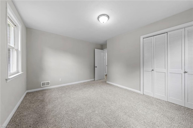 unfurnished bedroom with a closet and carpet