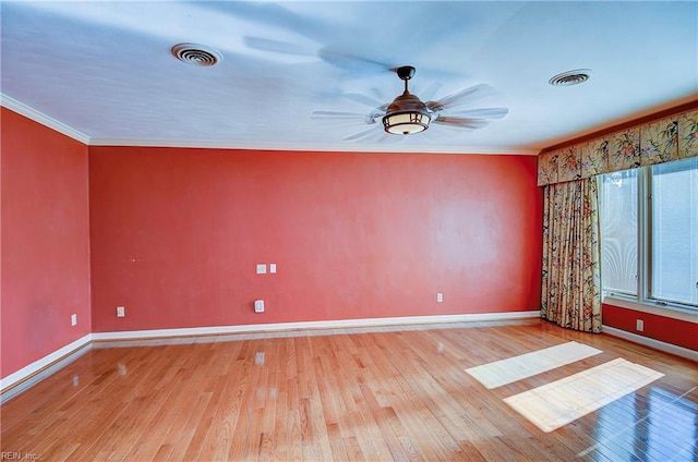 empty room featuring crown molding, ceiling fan, and light hardwood / wood-style floors