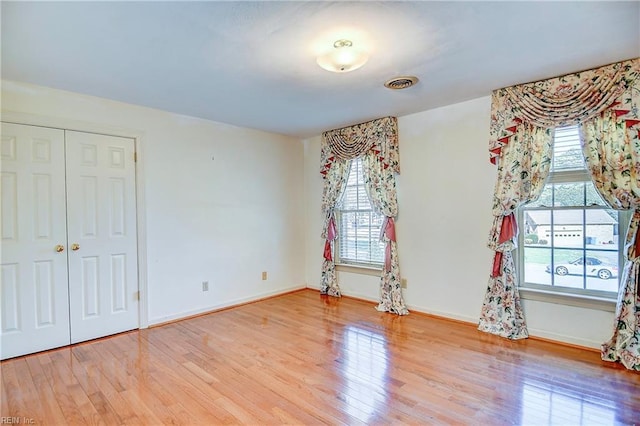 spare room with wood-type flooring