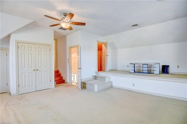 additional living space featuring vaulted ceiling, ceiling fan, and carpet flooring