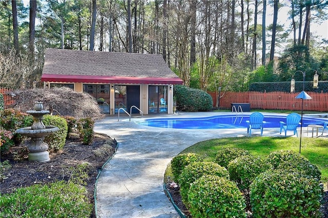 view of swimming pool featuring an outbuilding and a patio area