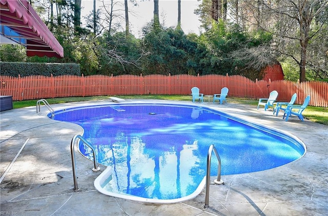 view of pool featuring a diving board and a patio area