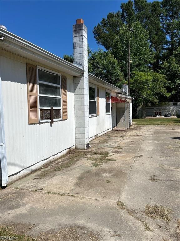 view of side of home with a patio