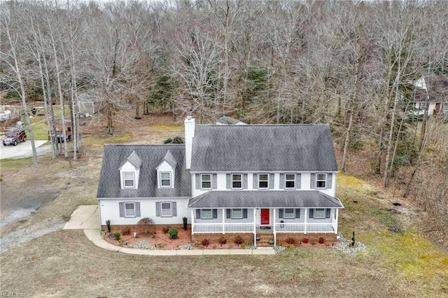 view of front of property with covered porch and a front lawn