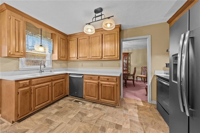 kitchen with pendant lighting, sink, a textured ceiling, and appliances with stainless steel finishes