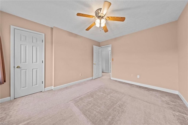 unfurnished bedroom with ceiling fan and light carpet