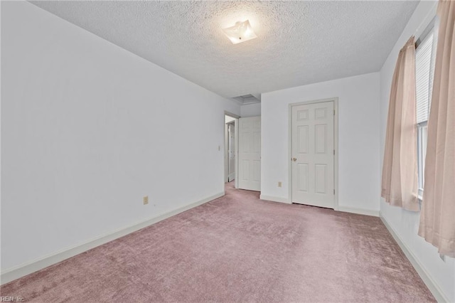 unfurnished bedroom with carpet and a textured ceiling