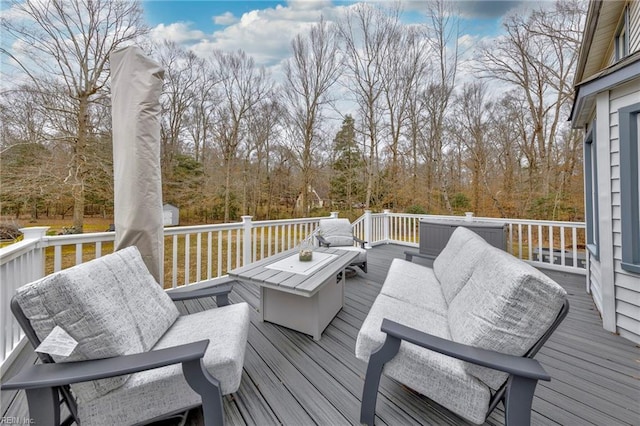 deck with an outdoor living space with a fire pit