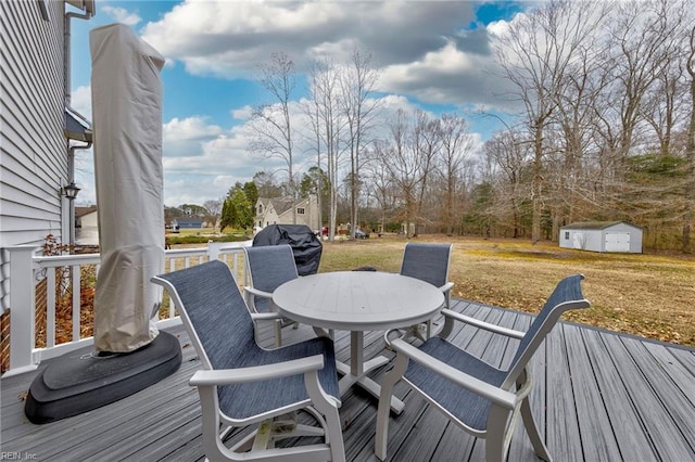 deck with a storage unit and a lawn