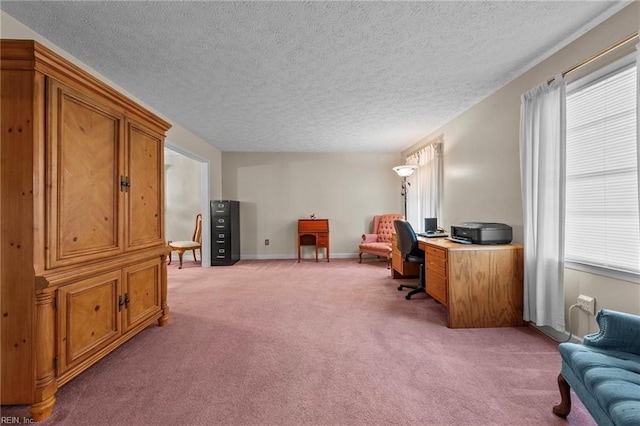 carpeted office featuring a textured ceiling